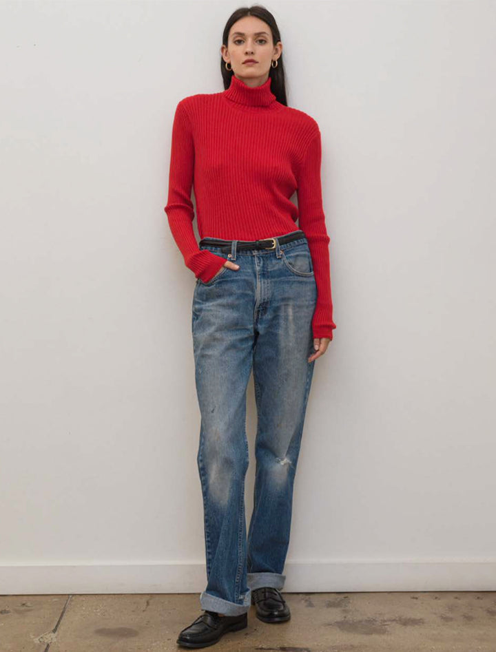 Model wearing Alex Mill's cristy ribbed turtleneck in red.