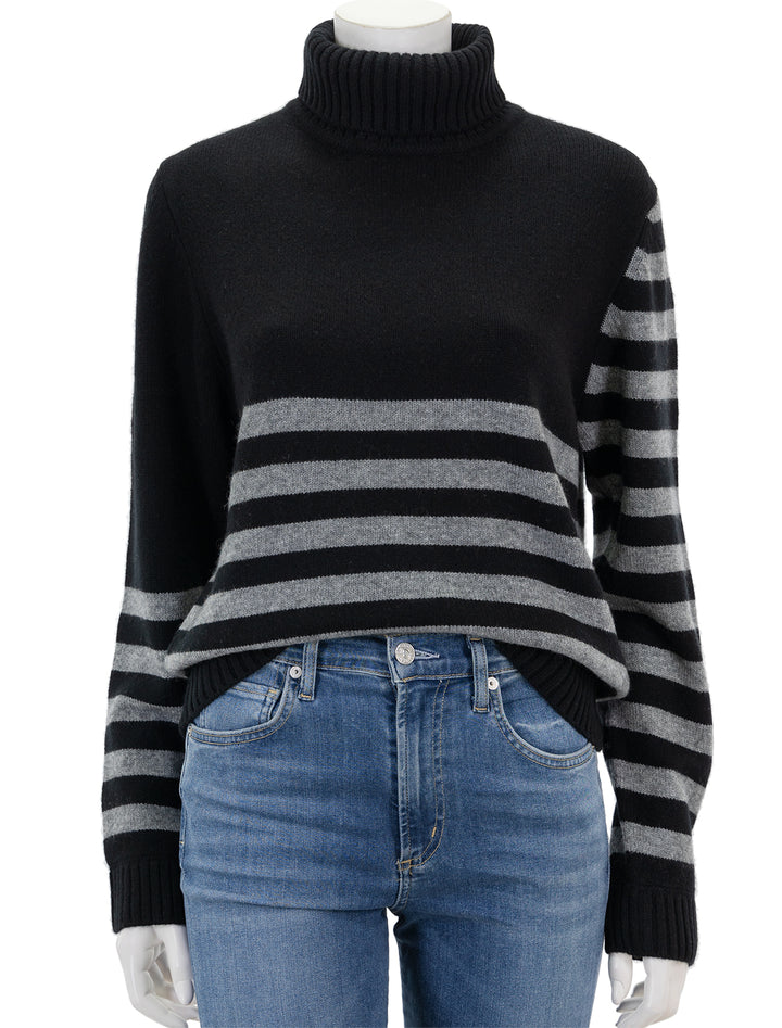 Front view of Jumper 1234's invert stripe roll collar sweater in black and cloud.
