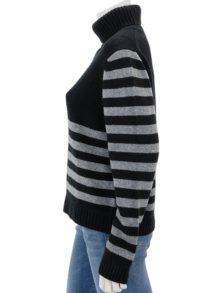 Side view of Jumper 1234's invert stripe roll collar sweater in black and cloud.