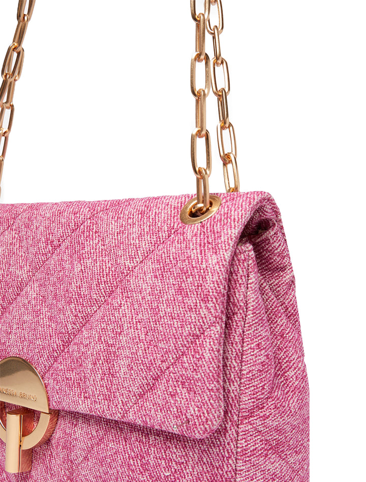 Close-up view of Vanessa Bruno's Moon MM Bag in fuchsia.