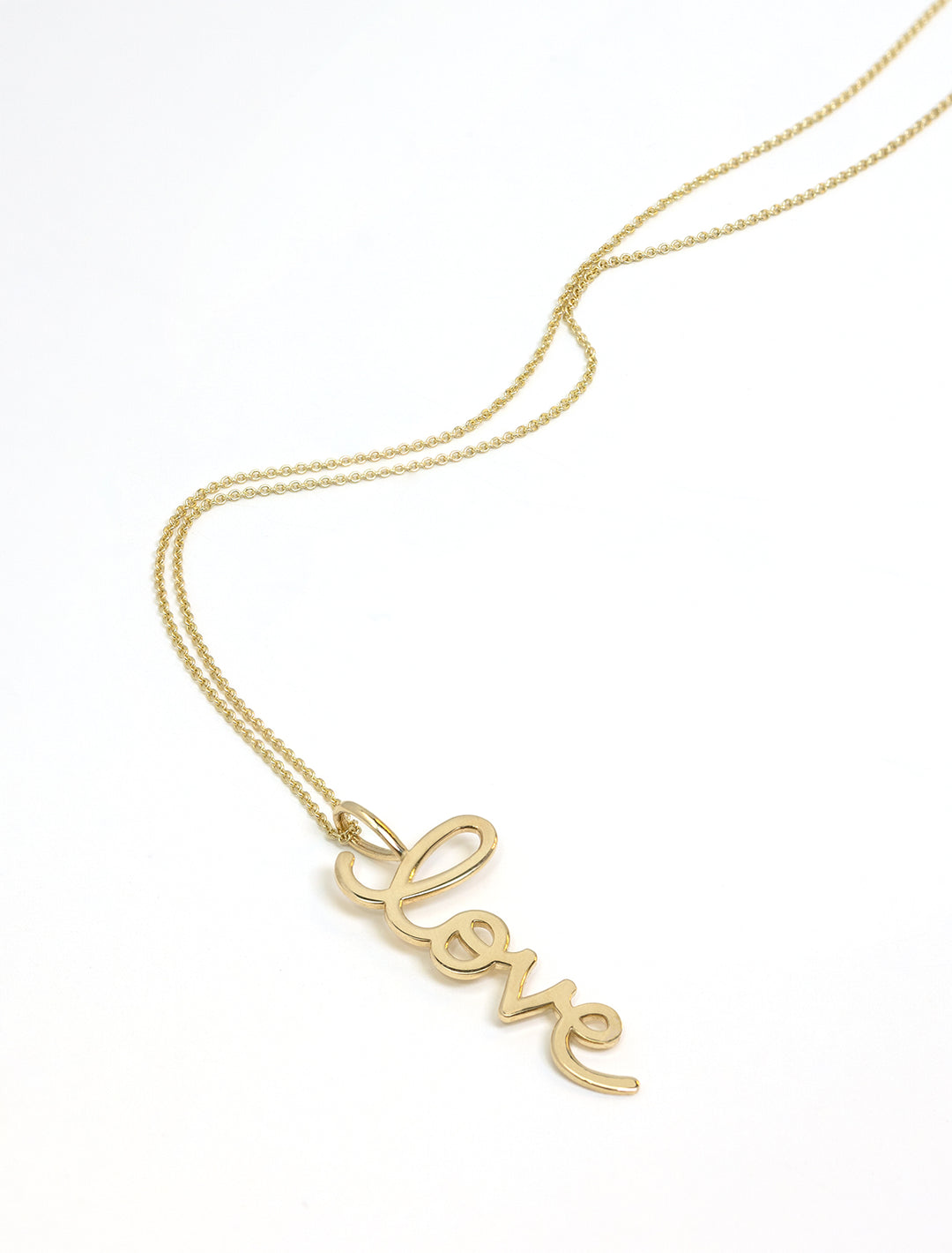 Stylized laydown of Sydney Evan's Large Pure Love Charm Necklace.