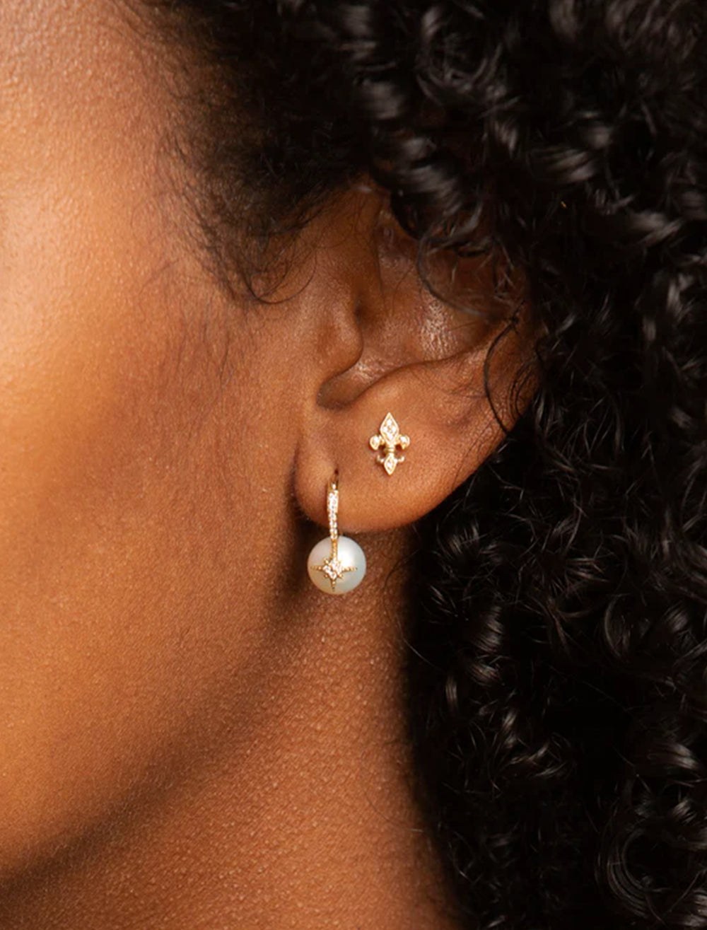 Model wearing Sydney Evan's pearl and pave starburst bead earrings.