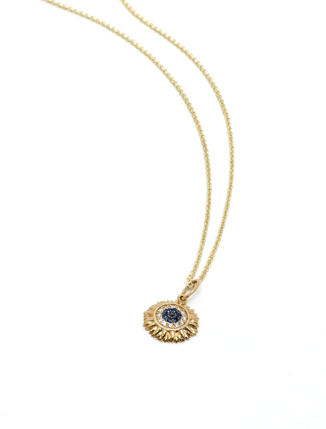 Close-up view of Sydney Evan's pave sunflower charm necklace with sapphire and diamond.