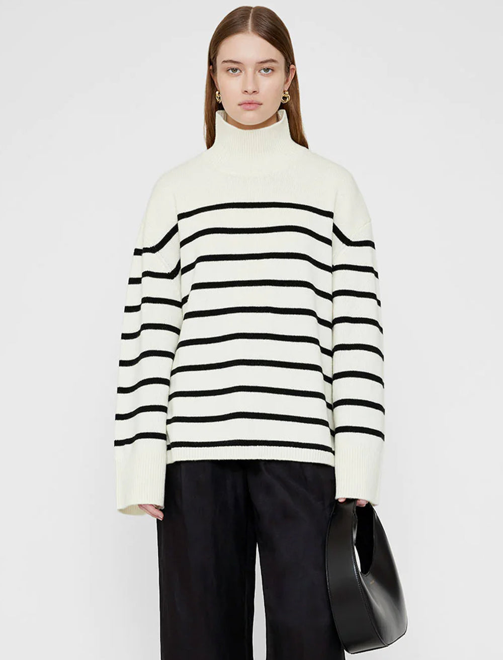 Model wearing Anine Bing's courtney sweater in ivory and black.