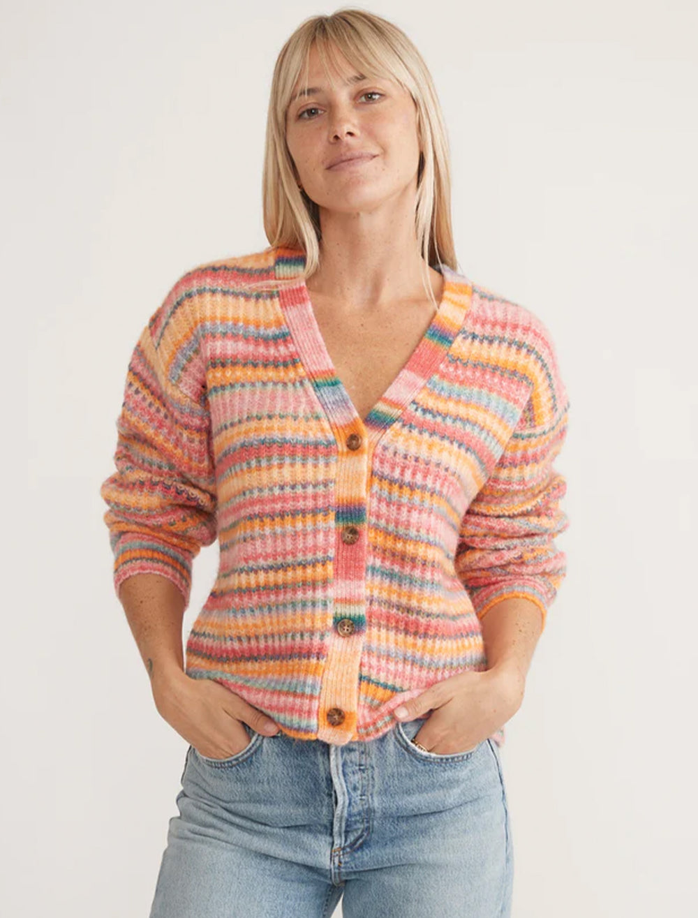 Model wearing Marine Layer's dream yarn cardigan in warm stripe.