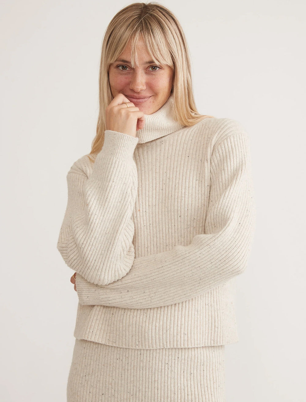 Model wearing Marine Layer's isla knit turtleneck in oatmeal.
