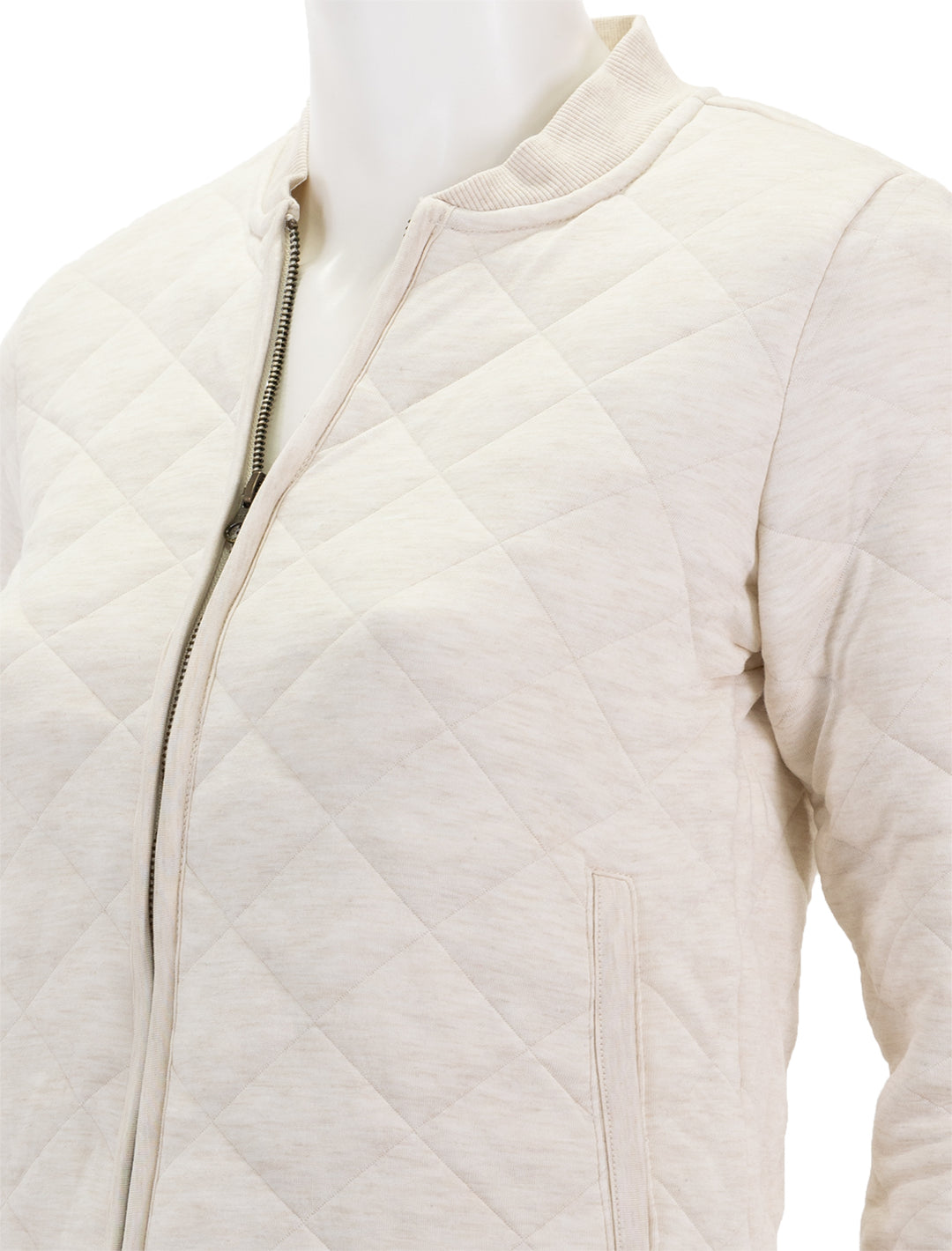 Close-up view of Marine Layer's updated corbet quilted bomber in antique white.