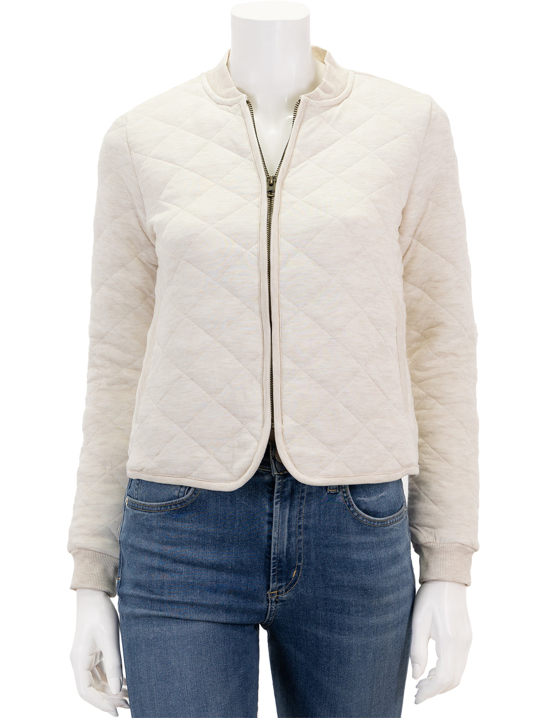 Front view of Marine Layer's updated corbet quilted bomber in antique white, zipped.