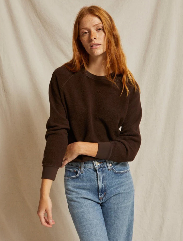 Model wearing Perfectwhitetee's ziggy inside out sweatshirt in cafe.