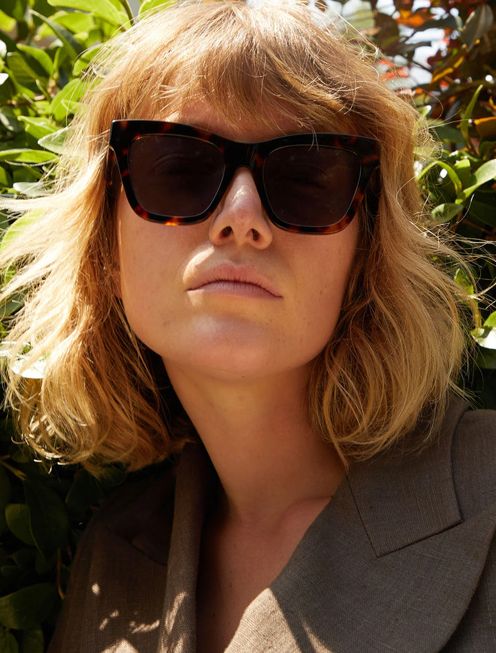 Model wearing Clare V.'s heather sunglasses in tortoise.