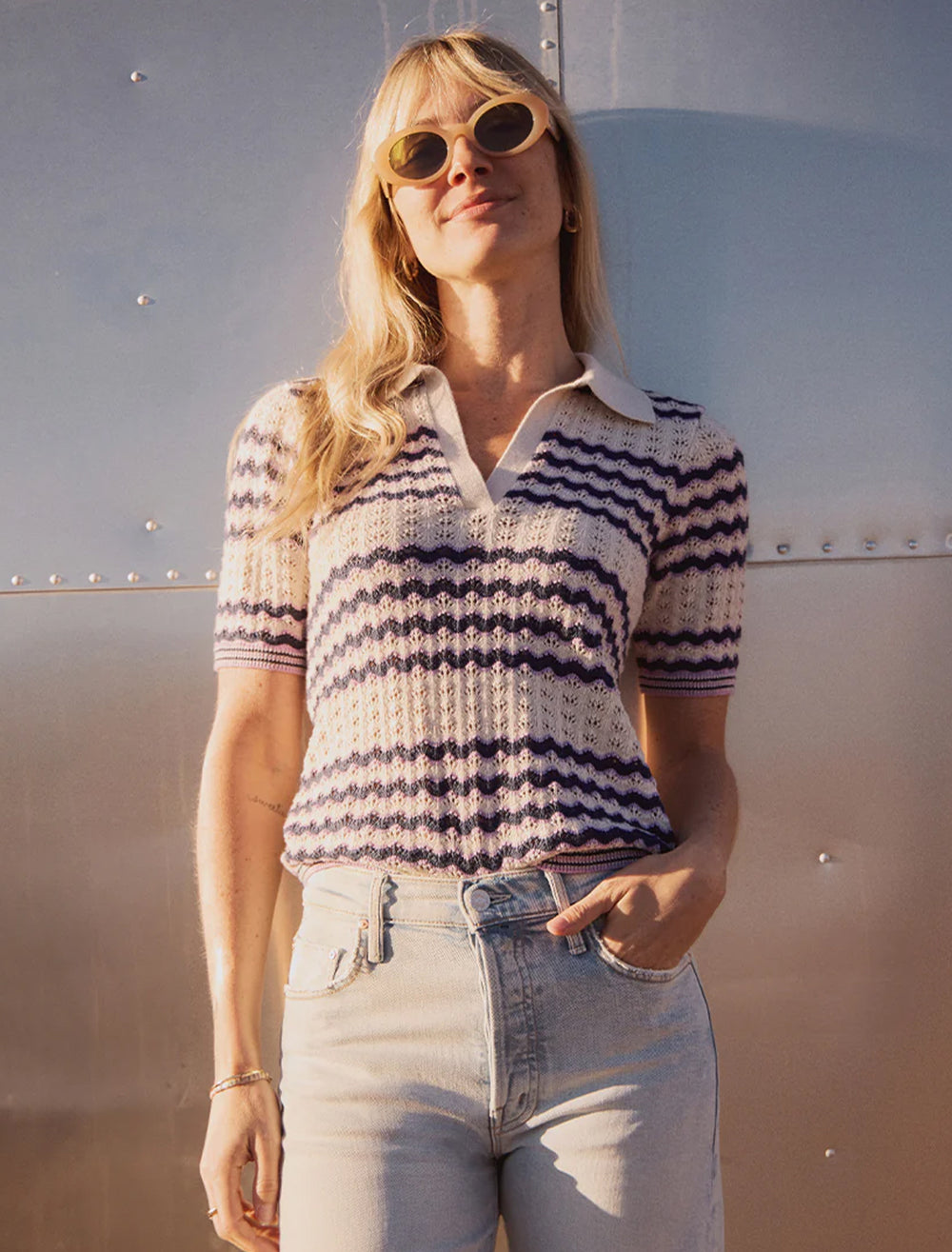 Model wearing Marine Layer's spencer polo sweater in cool wave.