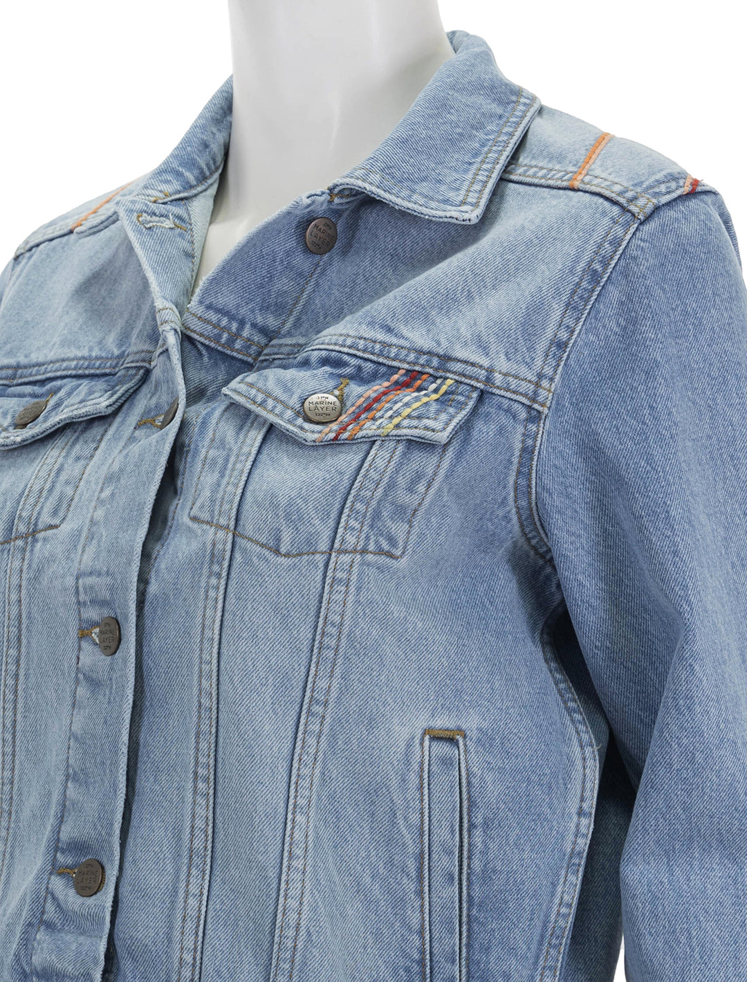 Close-up view of Marine Layer's embroidered denim jacket in light denim.