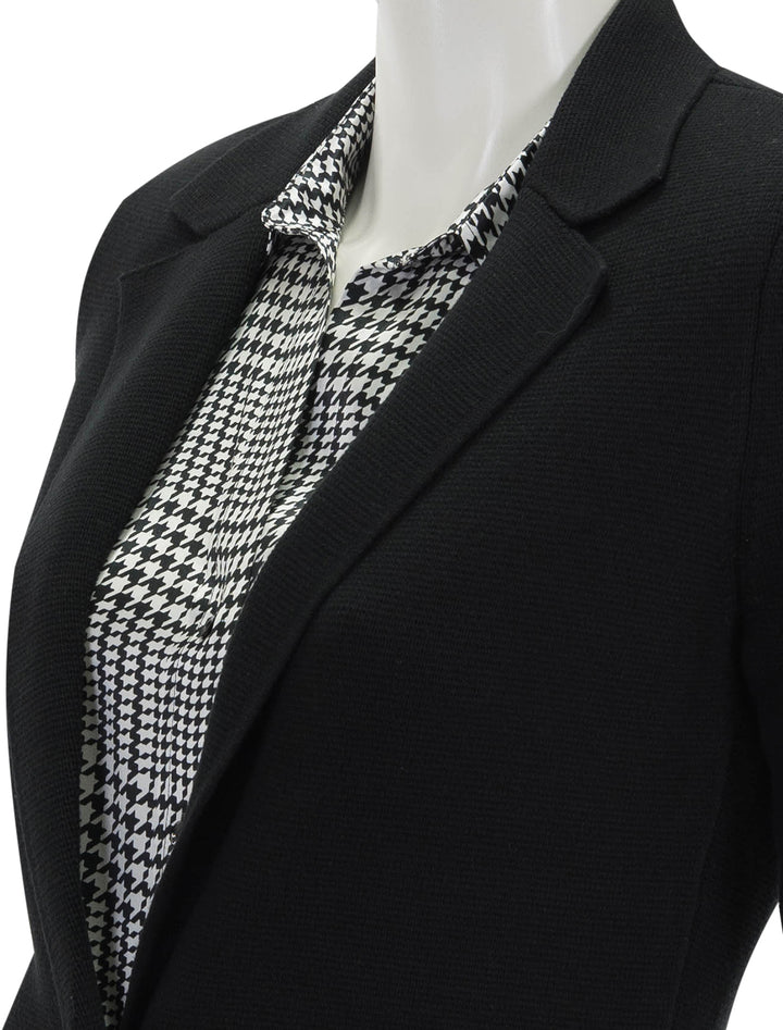 Close-up view of L'agence's lacey knit blazer in black.