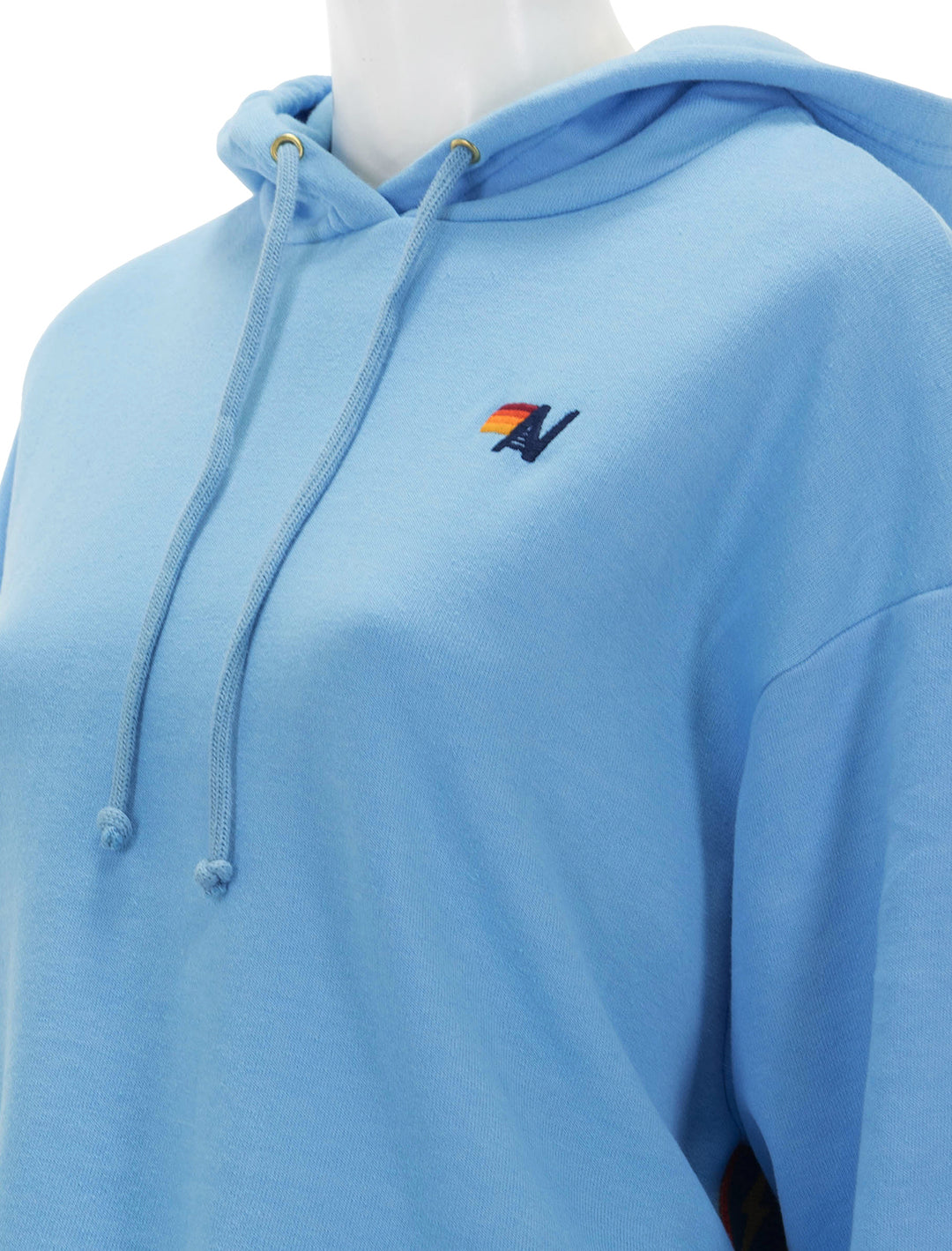 Close-up view of Aviator Nation's bolt stripe relaxed cropped pullover hoodie in sky.