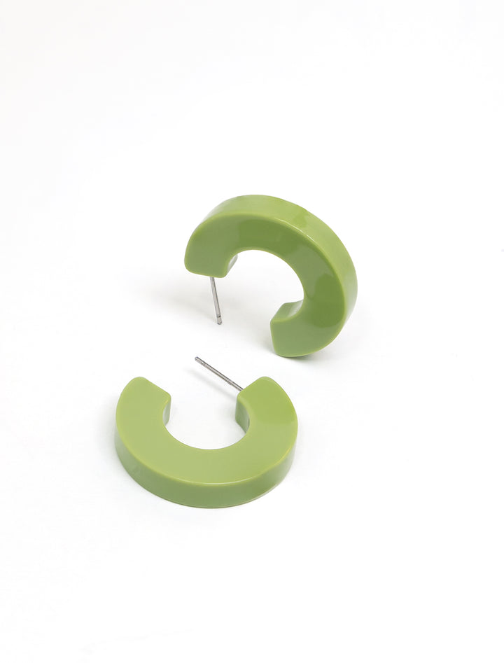 Laydown of Nat + Noor's ray hoops in kiwi.