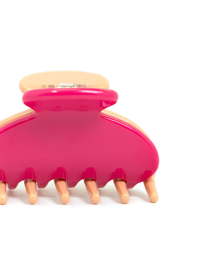 Close-up view of Nat + Noor's small hair claw in dragonfruit.