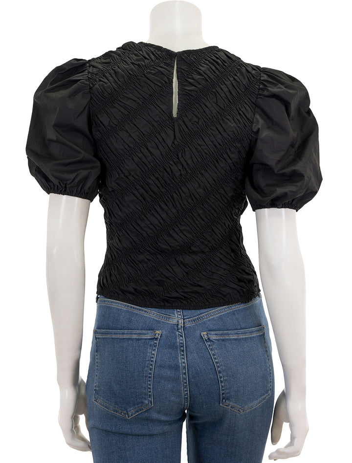 Back view of English Factory's asymmetrical smocked top in black.