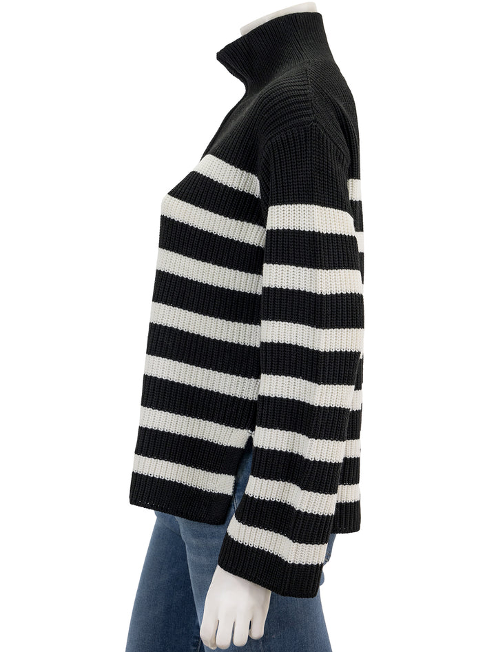 Side view of English Factory's striped half zip sweater in black and white.