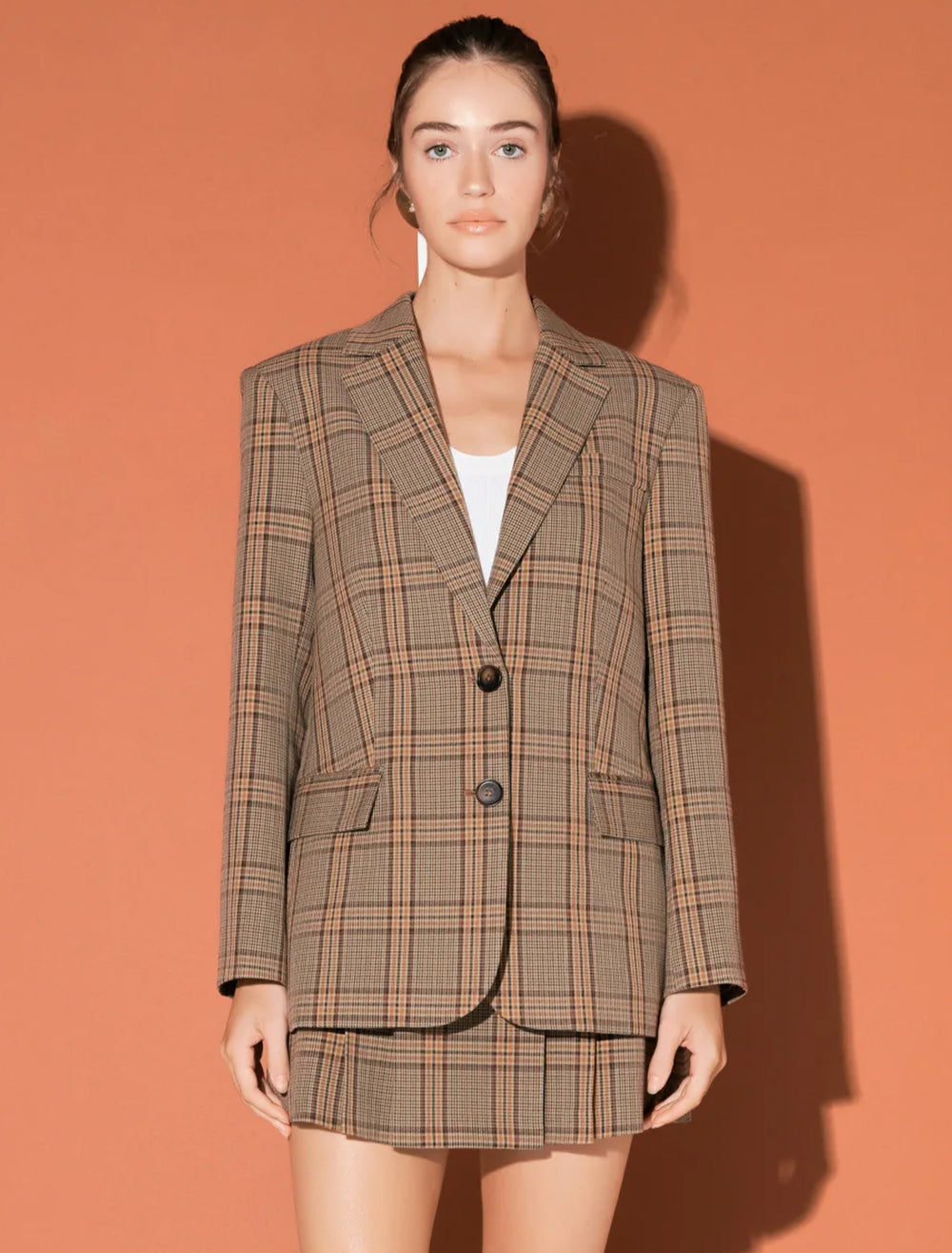 Model wearing English Factory's oversized check blazer in brown.