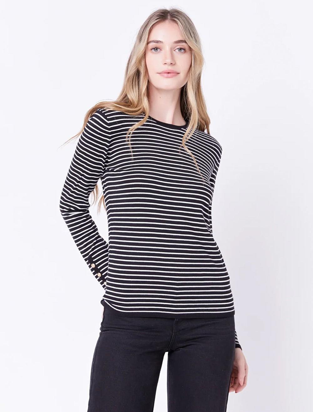 Model wearing English Factory's striped sweater with button detail in black and white.