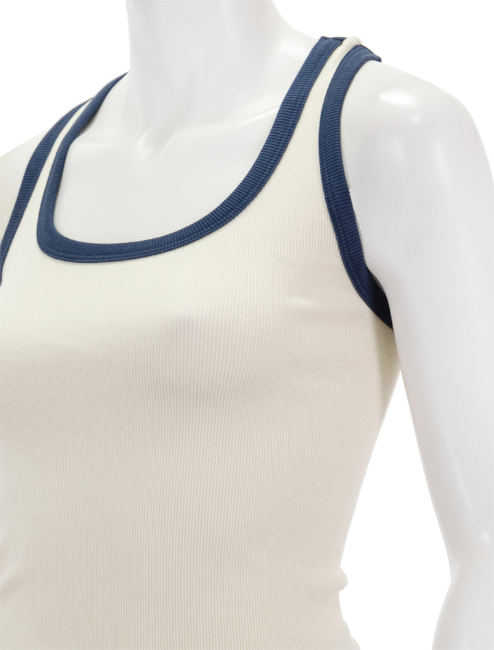 Close-up view of Sundry's scoopneck crop tank in cream and navy.
