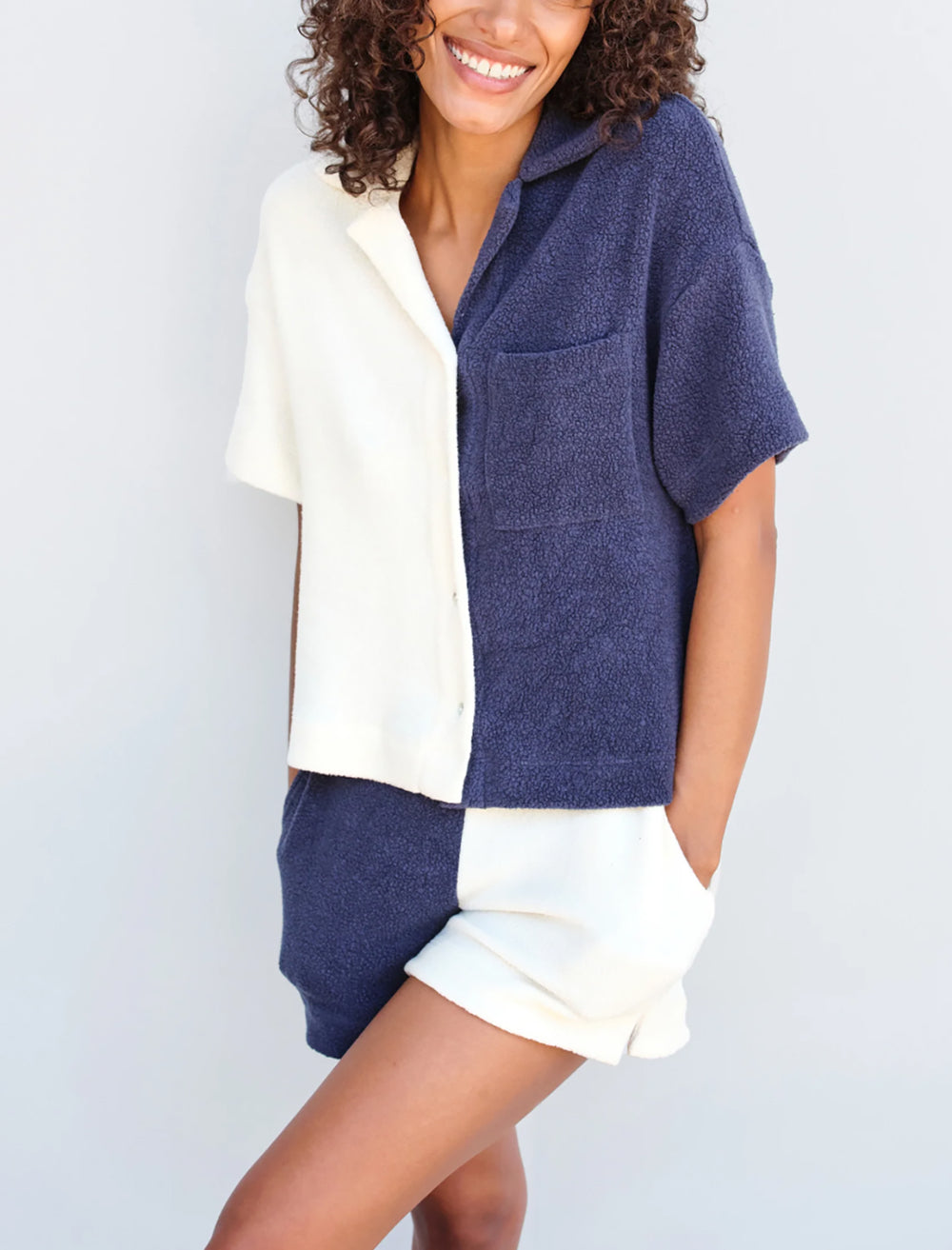 Model wearing Sundry's sherpa pull-on shorts in cream and navy.