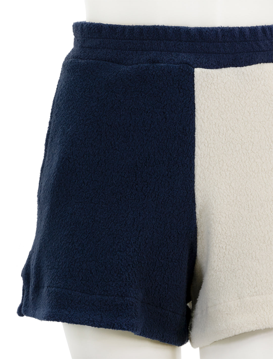 Close-up view of Sundry's sherpa pull-on shorts in cream and navy.