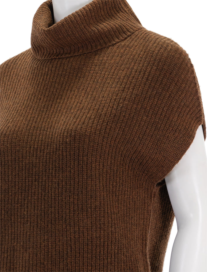 Close-up view of Lilla P.'s ribbed turtleneck sweater in copper.