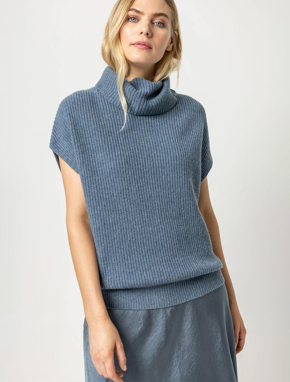 Model wearing Lilla P.'s ribbed turtleneck sweater in nautilus.