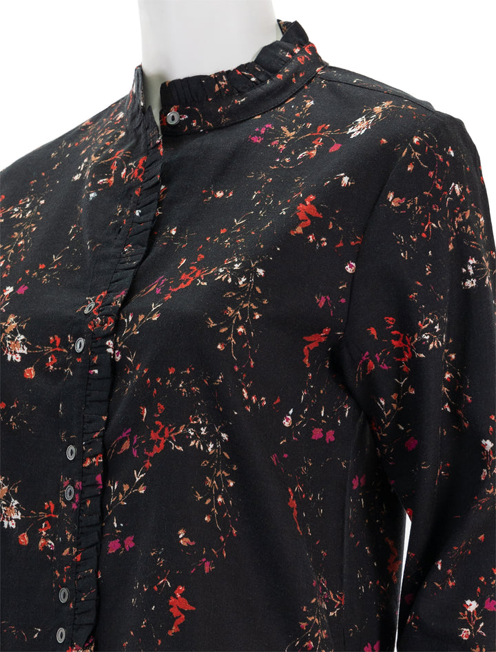Close-up view of Lilla P.'s ruffle button down blouse in black floral print.