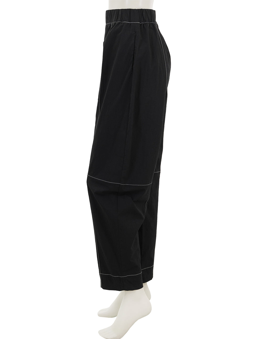 Side view of GANNI's curve pants.