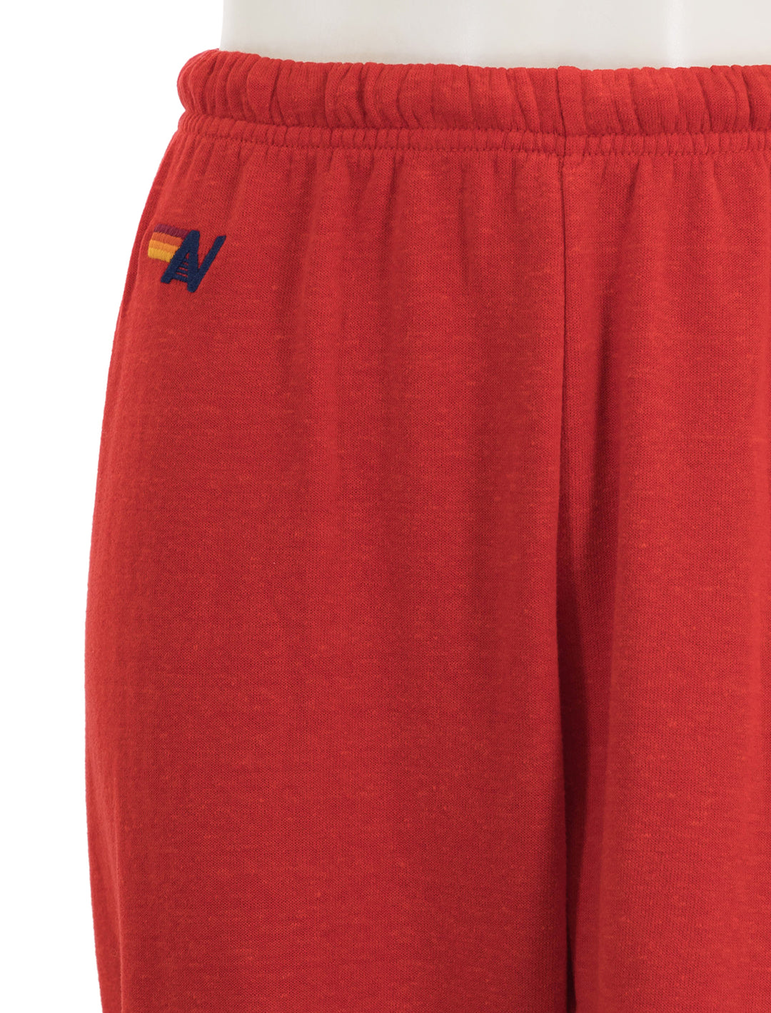 Close-up view of Aviator Nation's bolt - womens sweatpants in red and white.