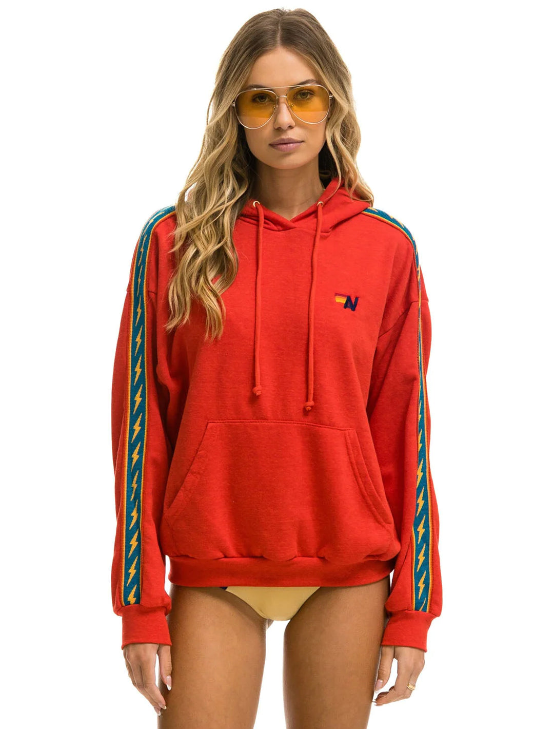 Model wearing Aviator Nation's bolt stripe relaxed pullover hoodie in red.