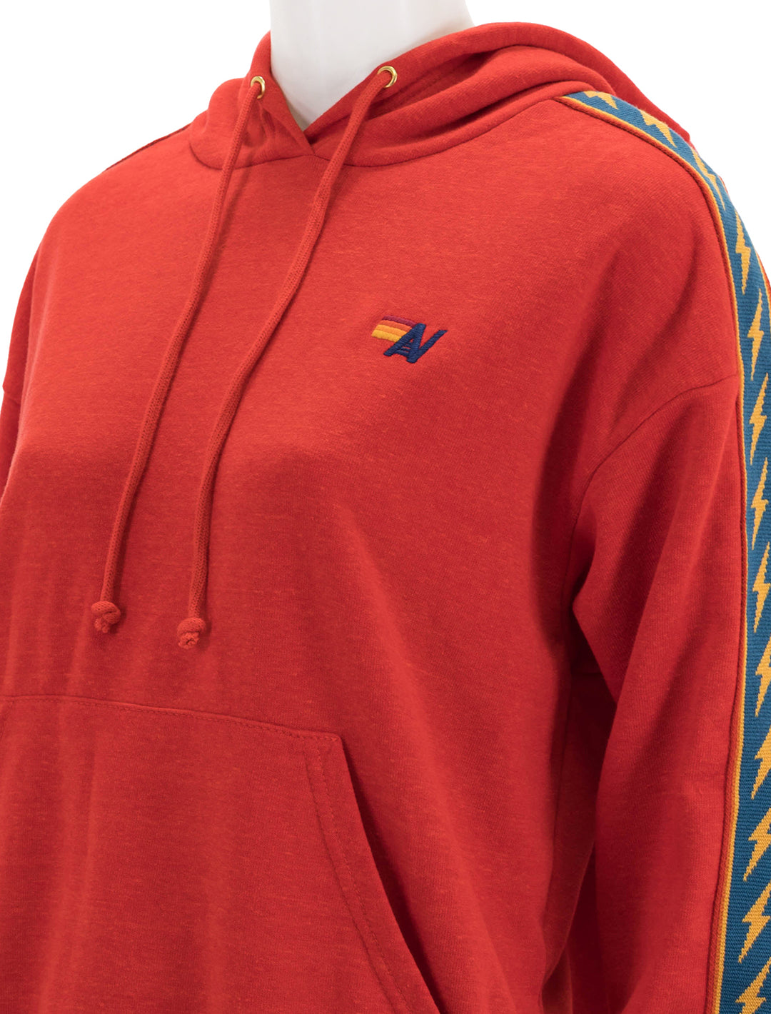Close-up view of Aviator Nation's bolt stripe relaxed pullover hoodie in red.