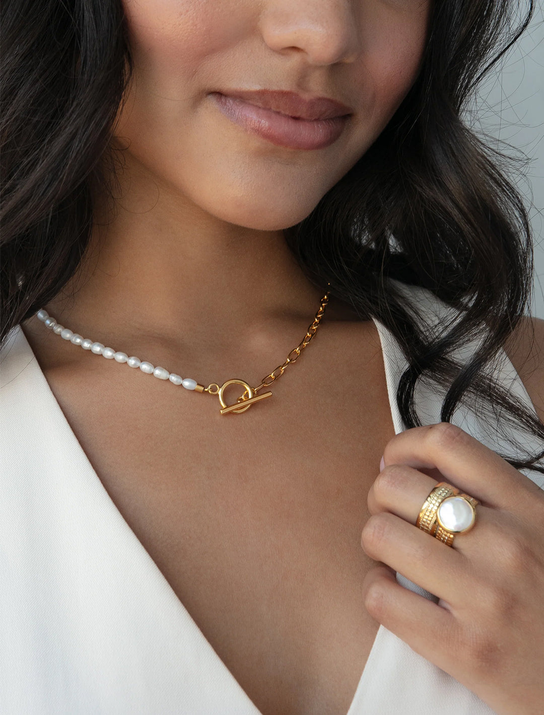 model wearing beaded pearl and chain necklace in gold