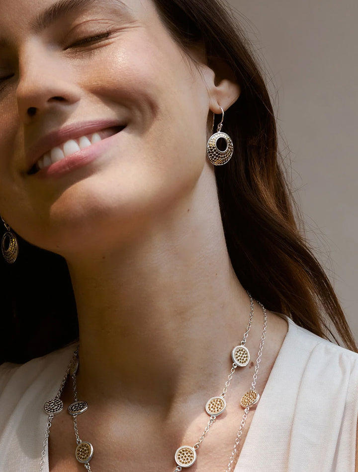 model wearing archive bali asymmetric circle earrings in two tone