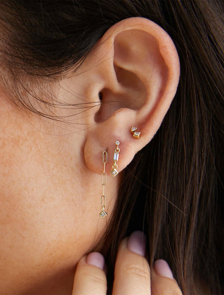 model wearing 14k paperclip chain drop earrings with princess diamonds
