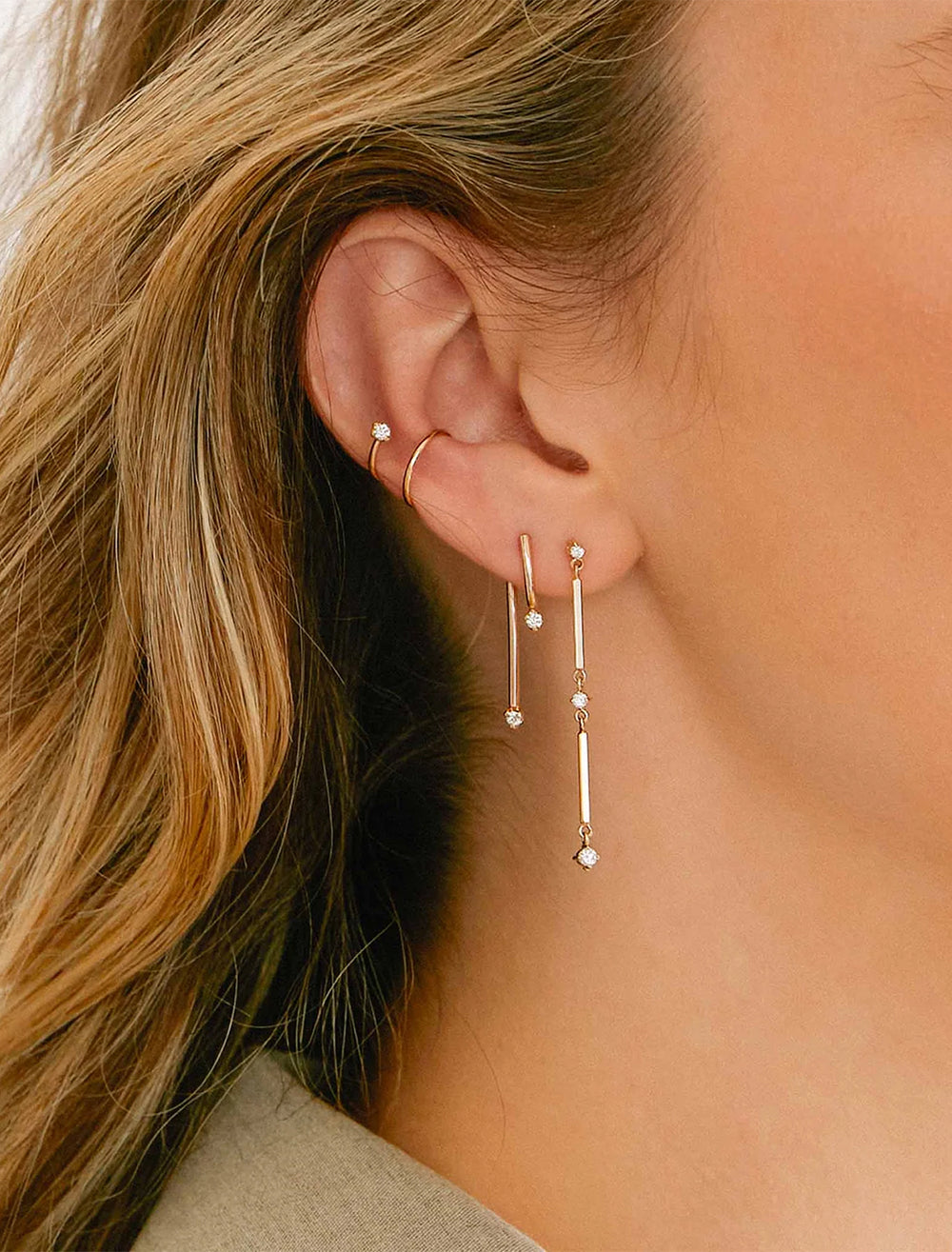 model wearing 14k mixed double bar and diamond drop earrings