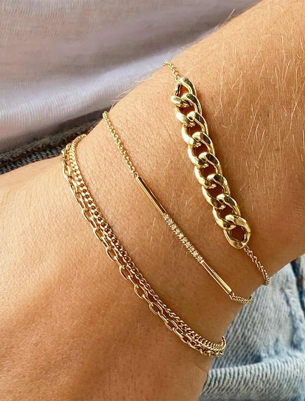 model wearing 14k xs curb chain and square oval link double chain bracelet