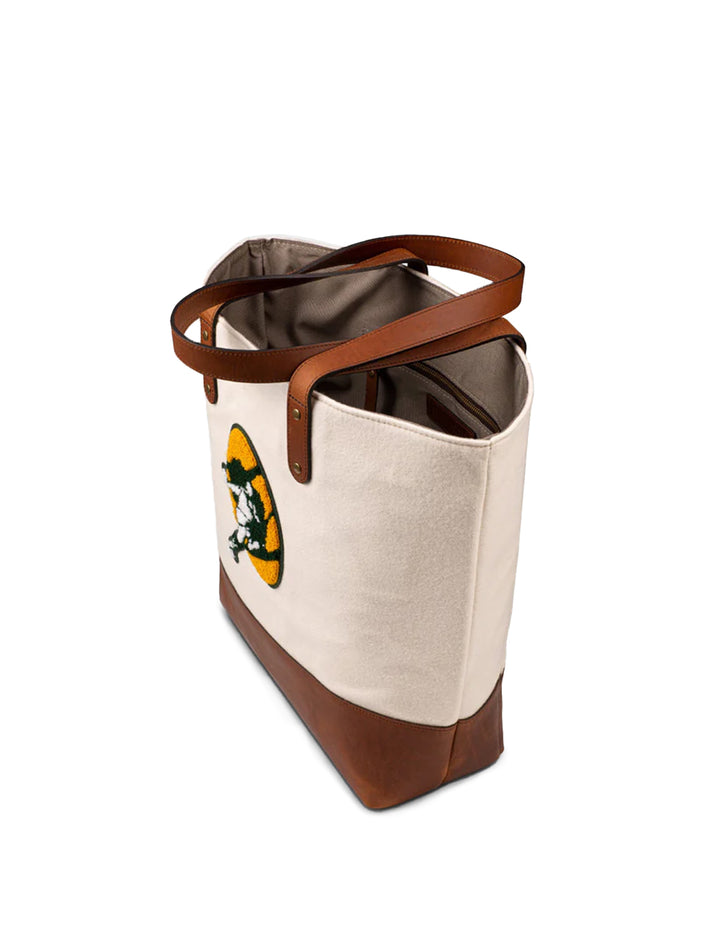 Side angle view of Heritage Gear's packers cream "titletown" tote bag.