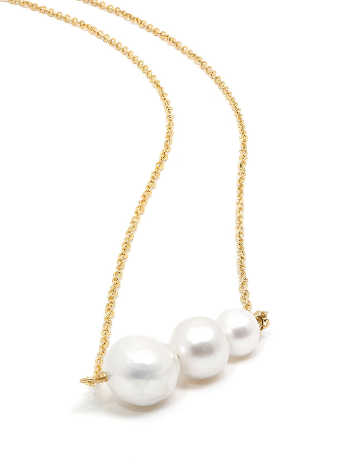 Stylized laydown of AV Max's pearl lumina necklace