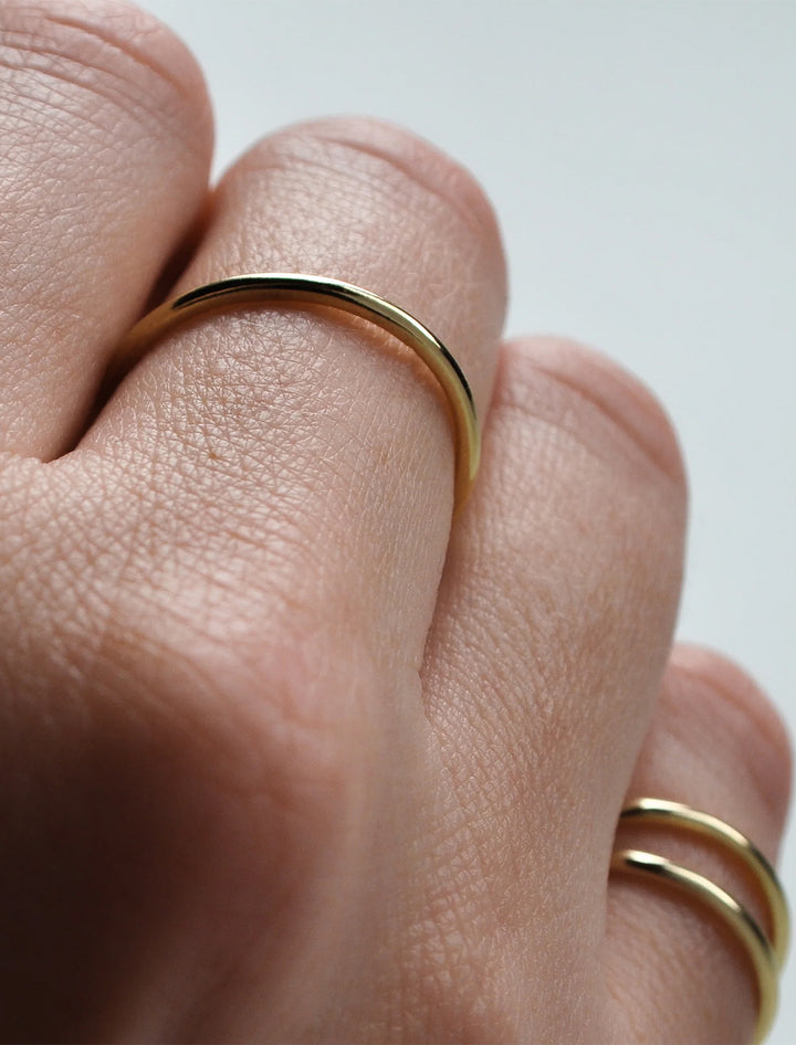 Model wearing THATCH's 14k gold plated dainty stacking ring.