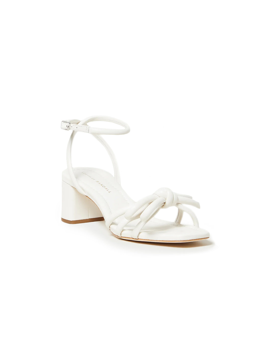 Front angle view of Loeffler Randall's leather bow mid heel sandal in white.