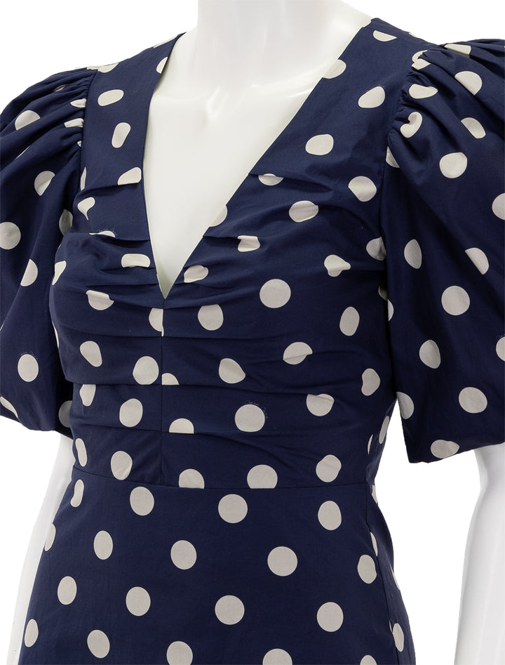 Close-up view of Cara Cara's aliza dress in classic navy dot.