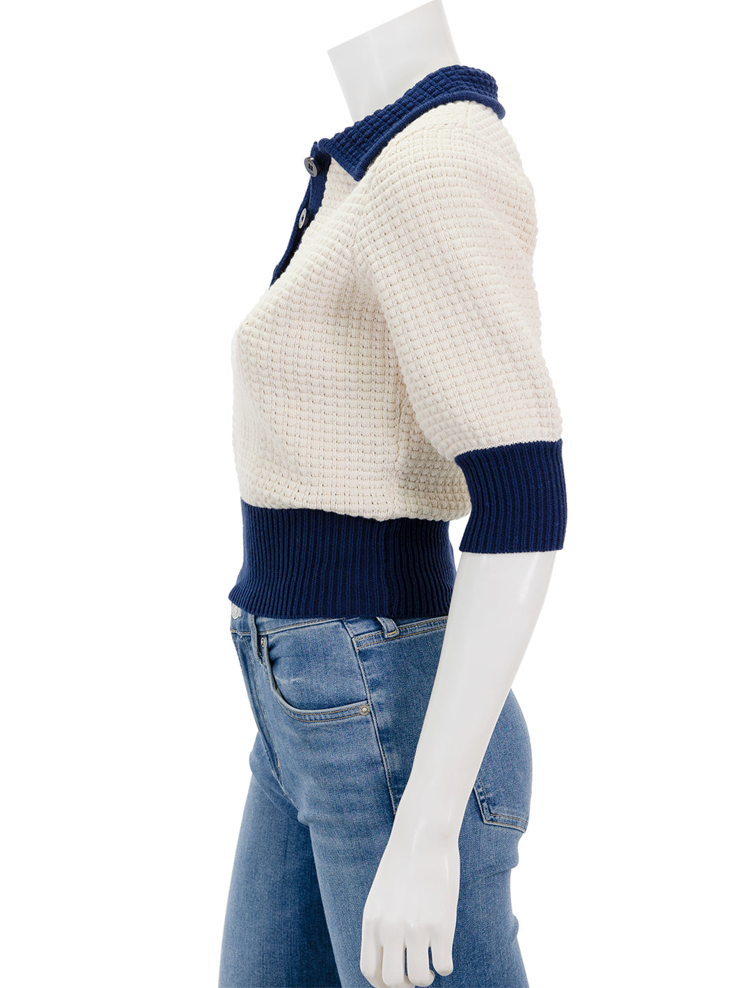 Side view of Staud's altea sweater in ivory and navy.