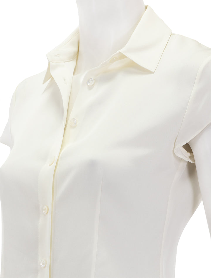 Close-up view of Theory's cap sleeve blouse in ivory.