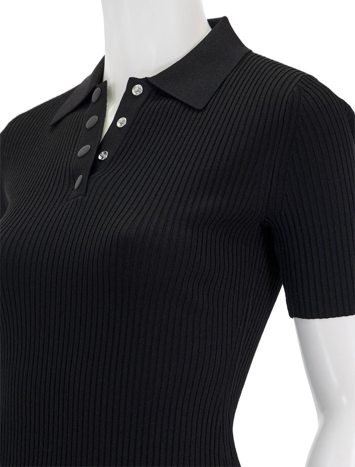 Close-up view of Theory's rib polo compact top in black.
