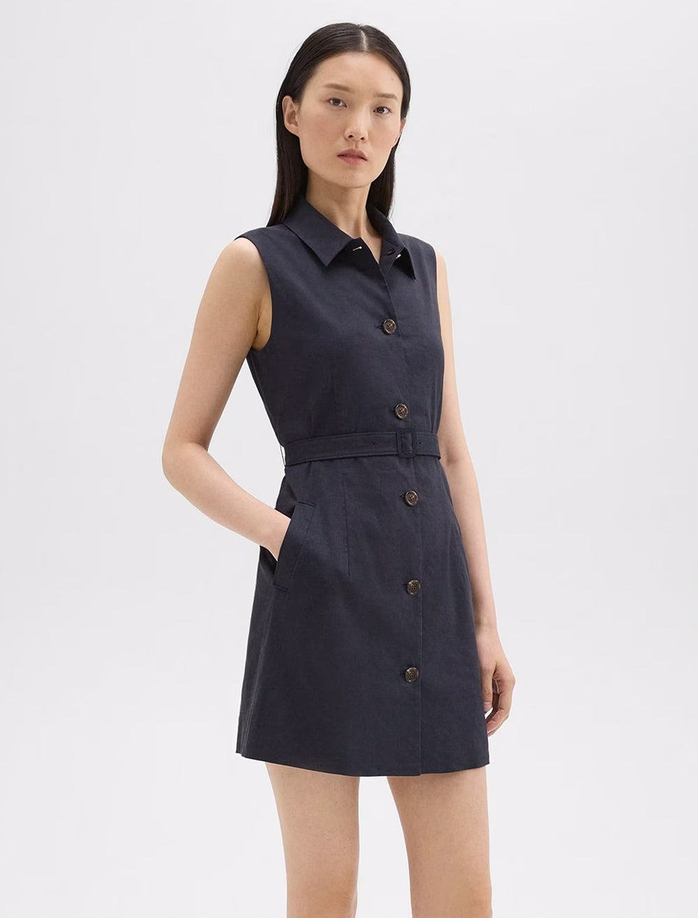 Model wearing Theory's belted sleeveless shirtdress in concord.