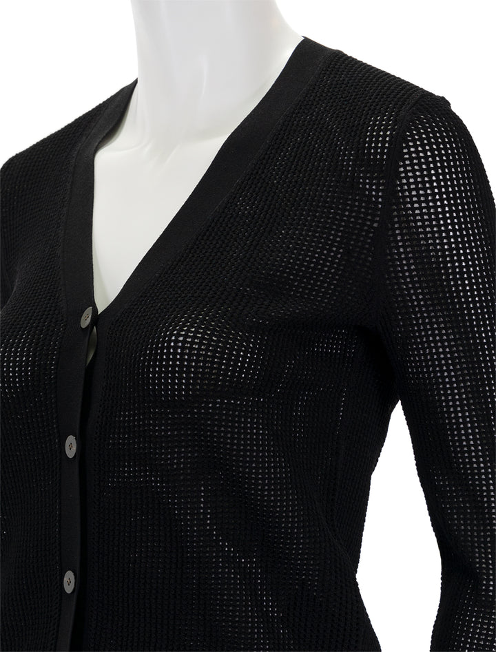 Close-up view of Theory's pointelle cardi in black.