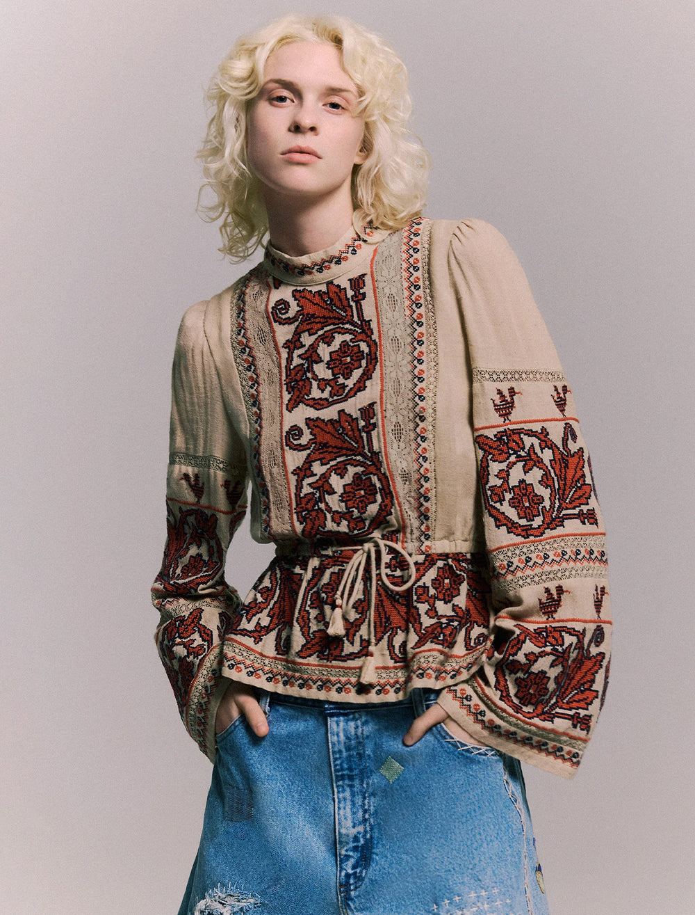 Model wearing Sea NY's beena embroidery long sleeve top in taupe.